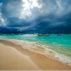 Storm and rain coming to the Caribbean sea of Playa del Carmen Mexico. Fishing boats anchored near the beach; Shutterstock ID 1589015776; your: Brian Healy; gl: 65050; netsuite: Lonely Planet Online Editorial; full: Best time to visit Playa del Carmen